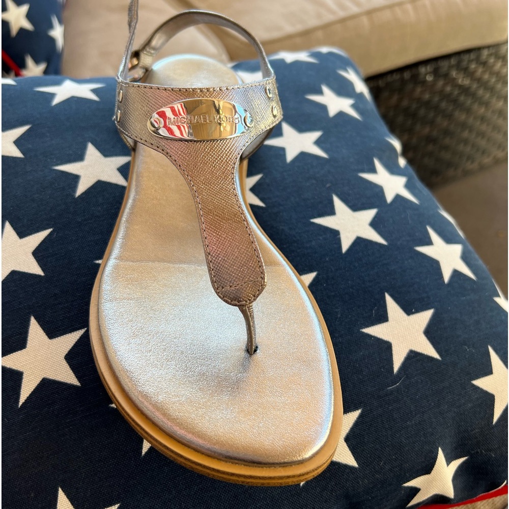 Michael Kors sandals brand new. Silver/sterling color. Never worn. New in box.